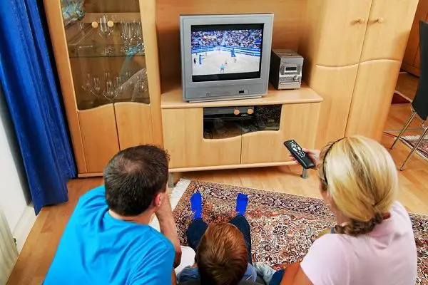 Family using universal remote to watch TV