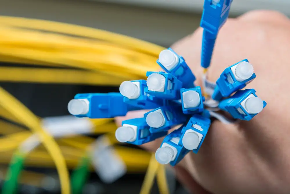 hand holding fiber optic cable