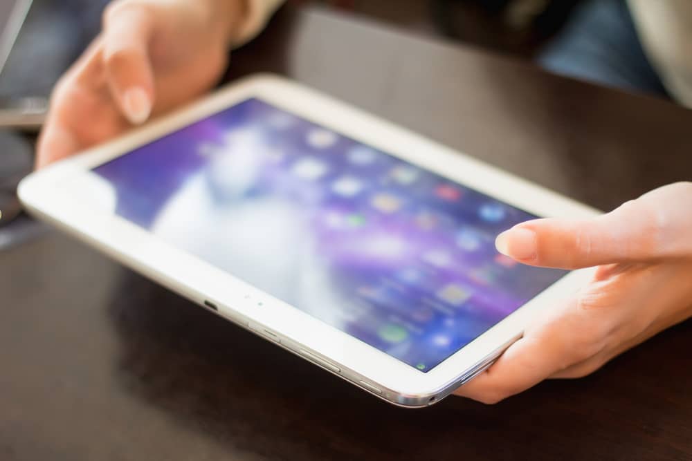 person holding mobile tablet