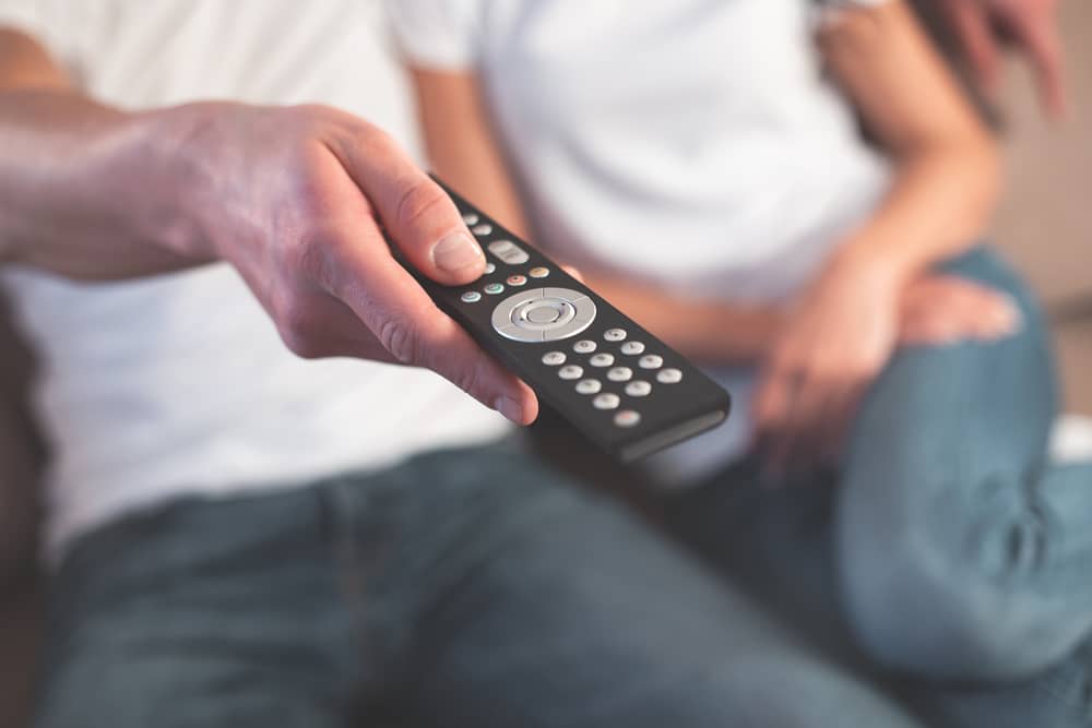 couple holding roku device