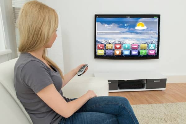 woman setting up smart tv