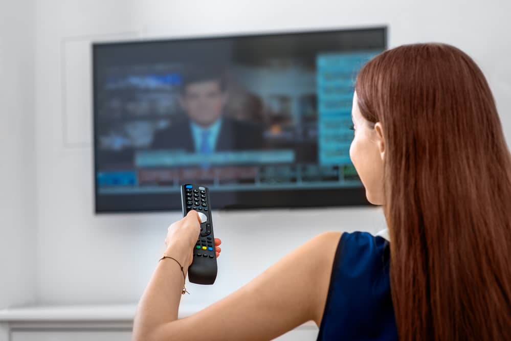 woman watching with roku on older tv