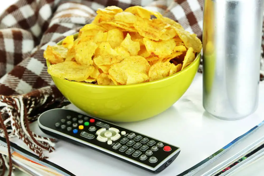 Bowl of chips with TV remote control